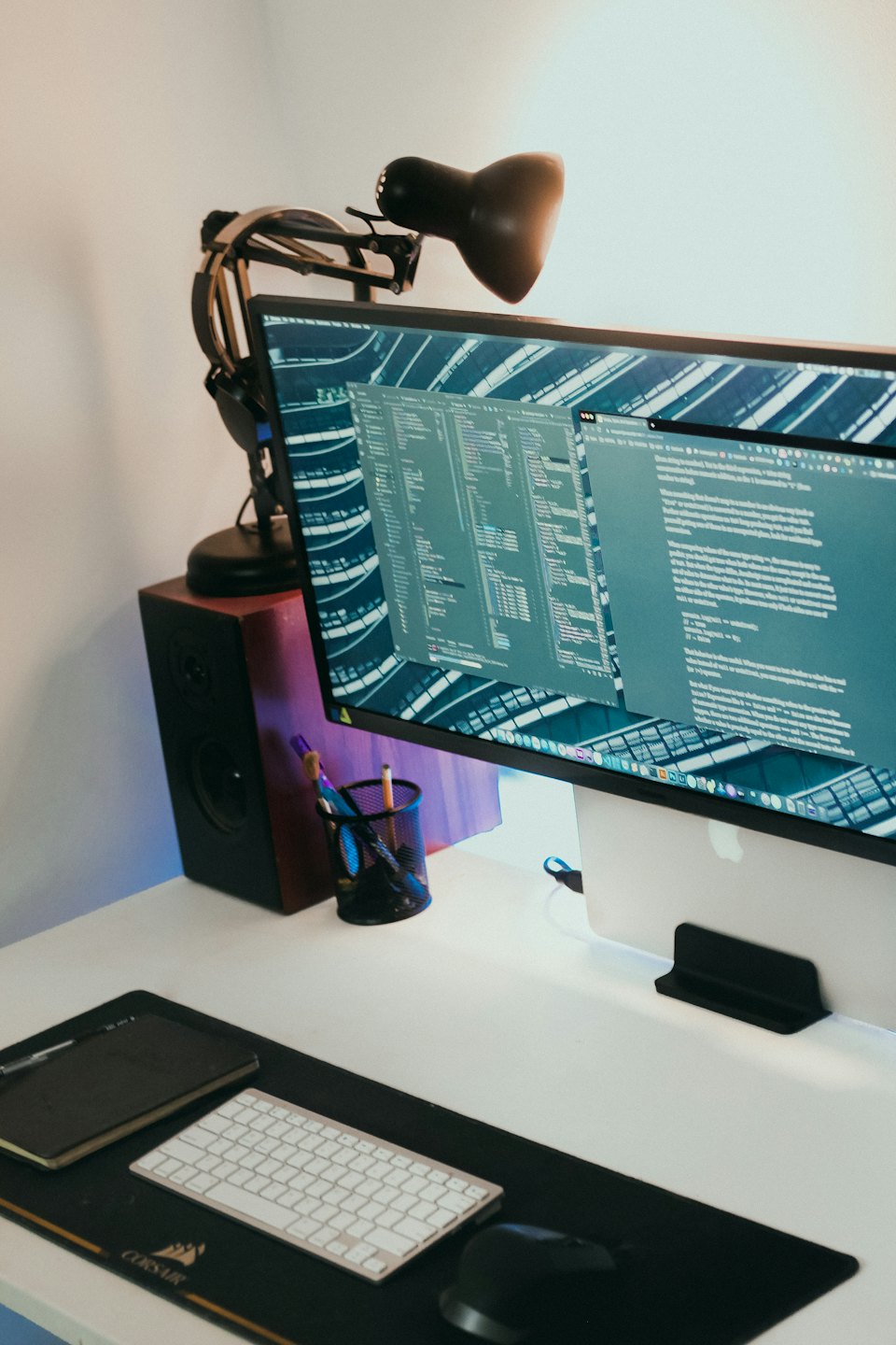 Computer monitor displaying code on a clean desk workspace.
